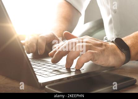 Closeup businessman male hands while typing on laptop. Hands typing on laptop computer, using contemporary notebook, texting message keyboard Stock Photo
