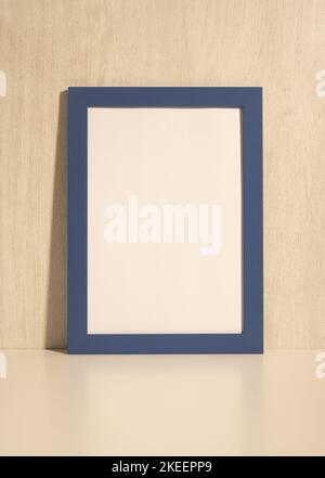 Vertical photo frame mockup on beige wall. blank diploma frame on white wall background. Picture frame mockup. blank diploma frame on white wall backg Stock Photo