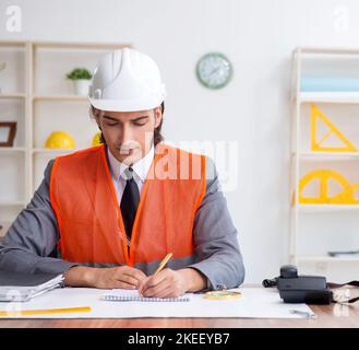 The young male architect working in the office Stock Photo
