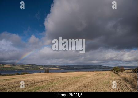 The image is of freshly cut hay fields looking towards the Cromarty Firth and bridge just north of Inverness Stock Photo