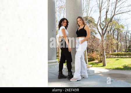 Young women friends enjoying themselves in the city park Stock Photo