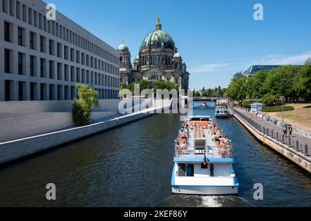 Berlin, Germany - June 23, 2022: Berliner Dom (Berlin Cathedral) at famous Museumsinsel (Museum Island) with excursion boat on Spree river Stock Photo