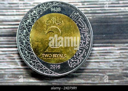 Reverse side of 2 SAR two Saudi Arabia riyals coin series 1438 AH 2016 with multiple coat of arms within the floral ornamentation and inscription of t Stock Photo