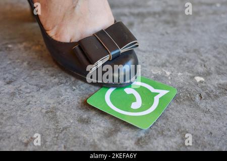 a person's foot with a green card in front of them to indicate that they are not wearing shoes Stock Photo