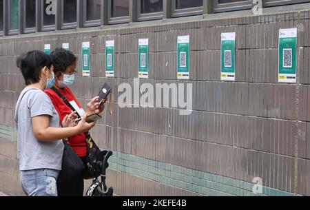 People use the LeaveHomeSafe to enter government-run wet markets at Tai Po Hui Market; as well as cooked food markets.   Using the contact-tracing app becomes mandatory to enter public buildings starting from November 01. 01NOV21  SCMP/ K. Y. Cheng Stock Photo