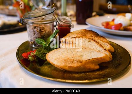 Table served with pate and croutons dish at plate close up, elegant appetizer at event restaurant banquet Stock Photo