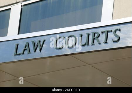 Law courts sign positioned above the entrance of a courthouse, legal ...