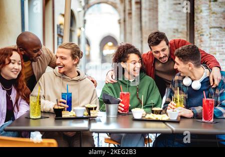 Multiracial trendy friends having fun moment at fancy cocktail bar - Beverage life style concept with people laughing together on happy hour out side Stock Photo