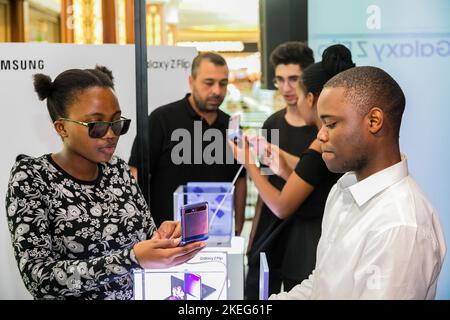 The Customers viewing Samsung phones at mall pop-up retail stand Stock Photo