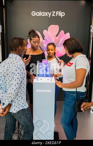 The Customers viewing Samsung phones at mall pop-up retail stand Stock Photo