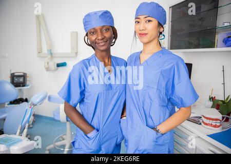Two female doctors in the dental office, colleagues of different ethnicities. Stock Photo