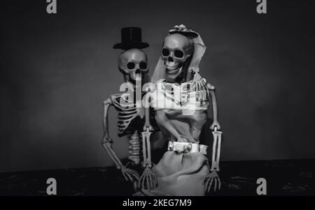 Fall 2022 - Black and White of a  Happily Married Skeleton Couple Posing for Wedding Poto Stock Photo