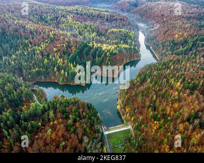 Aerial photograph of a drone flying over the Buhui Lake during autumn.  Photo taken on 29th of October 2022, near Anina city, Caras-Severin County, Ro Stock Photo