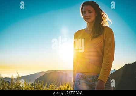 Description: Sporty woman walking barefoot in the evening sun on Pico do Ariero on a super beautiful hiking trail. Verade do Pico Ruivo, Madeira Islan Stock Photo