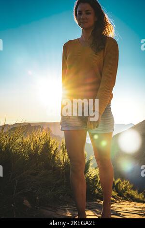 Description: Sporty woman walking barefoot in the evening sun on Pico do Ariero on a super beautiful hiking trail. Verade do Pico Ruivo, Madeira Islan Stock Photo