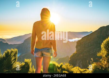 Description: Sporty woman walking barefoot in the evening sun on Pico do Ariero on a super beautiful hiking trail. Verade do Pico Ruivo, Madeira Islan Stock Photo