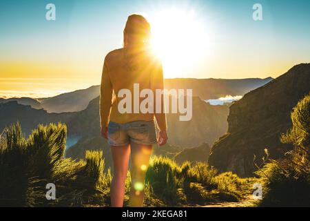 Description: Sporty woman walking barefoot in the evening sun on Pico do Ariero on a super beautiful hiking trail. Verade do Pico Ruivo, Madeira Islan Stock Photo