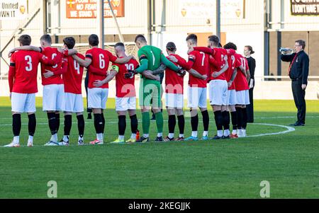 Broadhurst Park, Manchester, Lancashire, UK. 12th Nov, 2022. UK - FC United of Manchester team stand around the centre circle of the pitch at Broadhurst Park as the last post is played before a minute's silence in memory of the fallen in the wars. Credit: John Hopkins/Alamy Live News Stock Photo