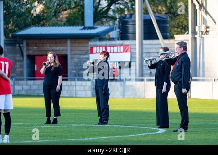 Broadhurst Park, Manchester, Lancashire, UK. 12th Nov, 2022. UK, Warrington - Both teams stand around the centre circle as a quartet play the last post before a minute's silence in memory of the fallen in the wars. Credit: John Hopkins/Alamy Live News Stock Photo