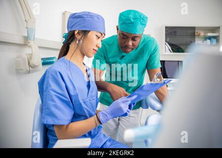 Two colleagues dentists in the dental office, work between doctors. Stock Photo