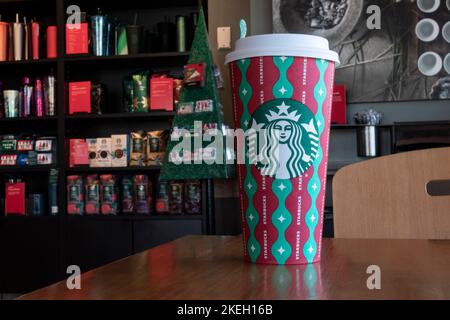 Starbucks Christmas espresso cups next to Nespresso machine