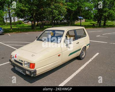 United Kingdom - June 27 2009; Vintage Reliant Robin faded yellow three wheeled car Stock Photo