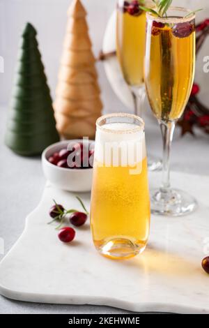 Festive Christmas mimosa with apple cider and cranberries Stock Photo