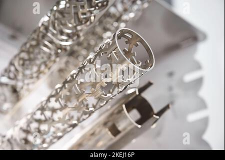 Metal pipes processed with laser cutting machine in shop Stock Photo