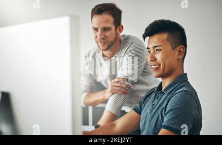 Collaborating on a new project. two designers working together on a project in an office. Stock Photo