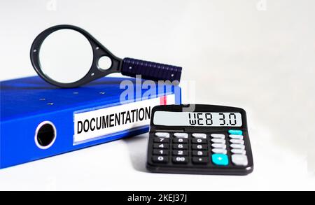 WEB 3.0 symbol. On the display of the calculator is the conceptual word WEB 3.0. Beautiful blue folder, white background. Business, technology concept Stock Photo