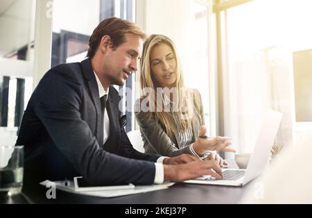 Plotting the course of their business. a two executives working together in an office. Stock Photo
