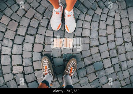 26 July 2022, Munster, Germany: Cobblestones Stolpersteine on a pedestrian path as memorial for died and deported jews victims during holocaust Stock Photo