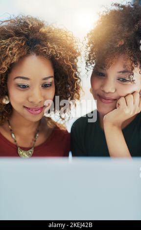 We work good together. two young designers working on a laptop together. Stock Photo