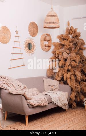 Stylish modern sofa in the home interior. Christmas tree made of dried flowers Stock Photo
