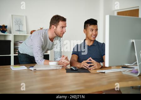 Positive and productive. two designers working together on a project in an office. Stock Photo