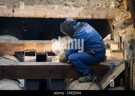 Bucharest, Romania - November 10, 2022: Details with a professional welder welding an industrial metallic pipeline. Stock Photo