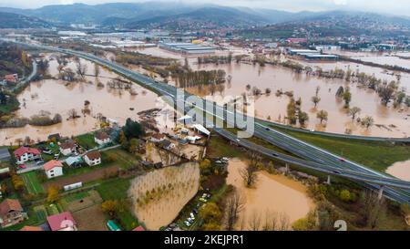 Aerial drone view of torrential rain causes flash floods in residential areas. Houses and roads surrounded by water. Climate change. Heavy rainfall. Stock Photo
