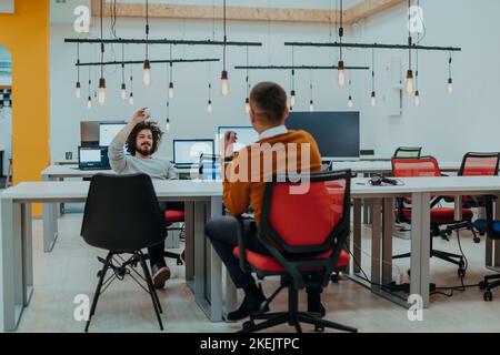 Two men having fun on a break from work in a modern office Stock Photo