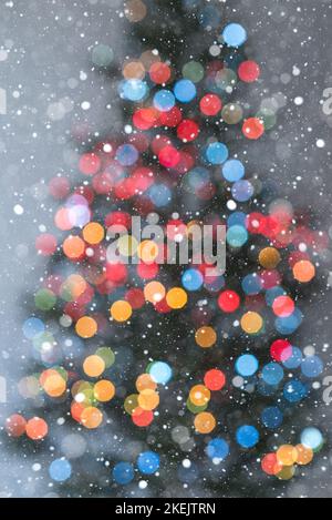 Christmas tree in multicolored lights and lots of snowflakes - soft focus Stock Photo