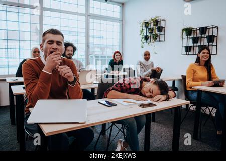 Tired woman napping on the table during a lecture in the classroom Stock Photo