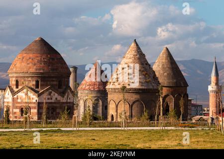 Erzurum Cultural Road Project , Three cupolas (Turkish: Üç Kümbetler) . Erzurum , Turkey. The double minaret madrasah in the background. Seljuk period. Stock Photo