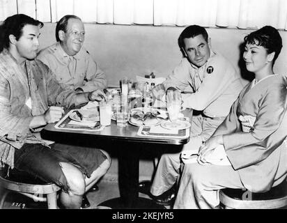MARLON BRANDO PAUL FORD GLENN FORD and MACHIKO KYO having lunch at MGM Studios in Hollywood during a break in filming of THE TEAHOUSE OF THE AUGUST MOON 1956 director DANIEL MANN book Vern J. Sneider play / screenplay John Patrick producer Jack Cummings Metro Goldwyn Mayer Stock Photo