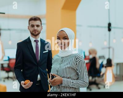 Portrait of a Muslim African American businesswoman at work while standing in the middle of a modern office. Stock Photo