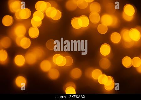 Abstract background, orange bokeh on a black background, festive background. Stock Photo
