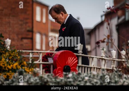 HEREFORD, UNITED KINGDOM - NOVEMBER 13, 2022: Conservative MP Jesse Norman lays a wreath as Hereford marks Remembrance Sunday on the 100th anniversary of the Eleanor Cross in St Peters Square. Designed in the form of an Eleanor Cross, the 30ft high Memorial was unveiled and dedicated on 7th October, 1922 in commemoration of about 2000 Herefordshire service men and women who gave their lives in the 1914-1918 War. Credit: Jim Wood/Alamy Live News Stock Photo