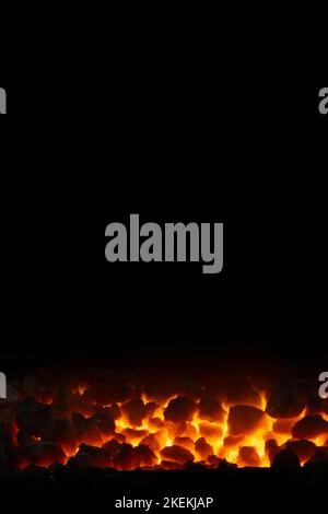 hot coals in forge against black background Stock Photo