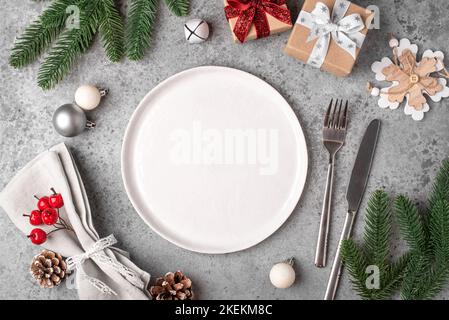 Christmas place setting on gray table. Stock Photo