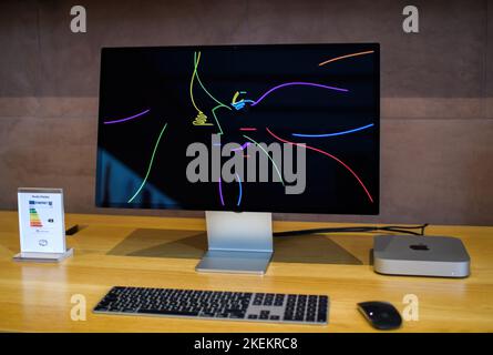 Paris, France - Oct 28, 2022: Front view of new Apple Computers MacMini computer workstation with M2 M3 CPU connected to the Studio Display 5k Retina monitor showing Apple colorful logotype Stock Photo