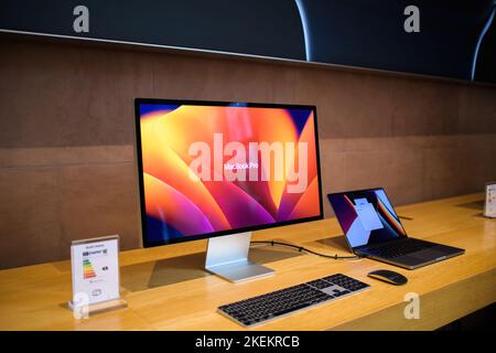 Paris, France - Oct 28, 2022: Side view of new Apple Computers MacBook Pro connected to the Studio Display 5k Retina monitor Stock Photo