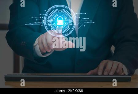 Businessman press on digital screen interface big data analytics with shield guard to protected from cyber attacks and personal data security. Network Stock Photo